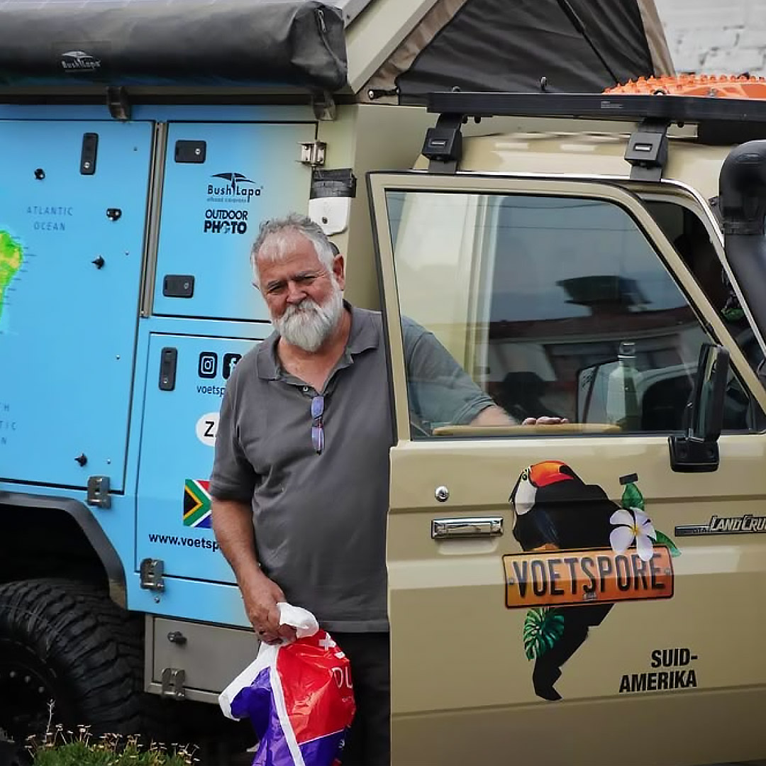 A man standing in front of a 4x4